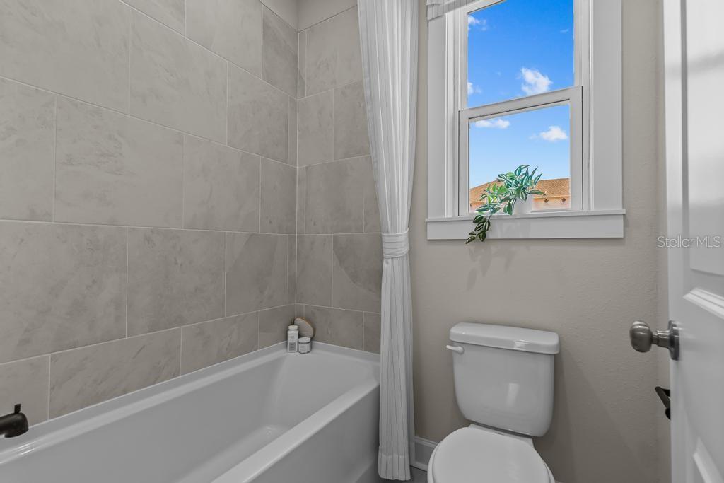 60 Pegasus Road Flagler Beach, FL 32136 - Photo 10 of 51 a white toilet sitting next to a bath tub