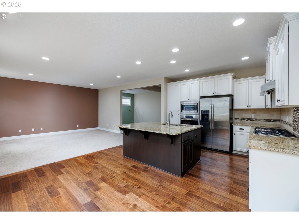 15997 Northwest Rossetta Street Portland, OR 97229 - Photo 13 of 36 a kitchen with refrigerator and cabinets