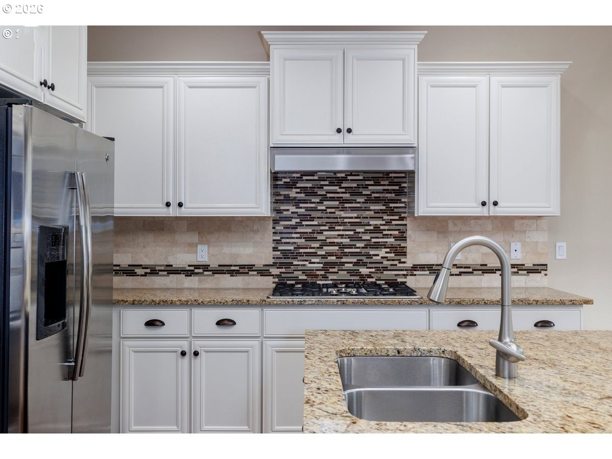 15997 Northwest Rossetta Street Portland, OR 97229 - Photo 14 of 36 a kitchen with stainless steel appliances granite countertop a sink stove and refrigerator