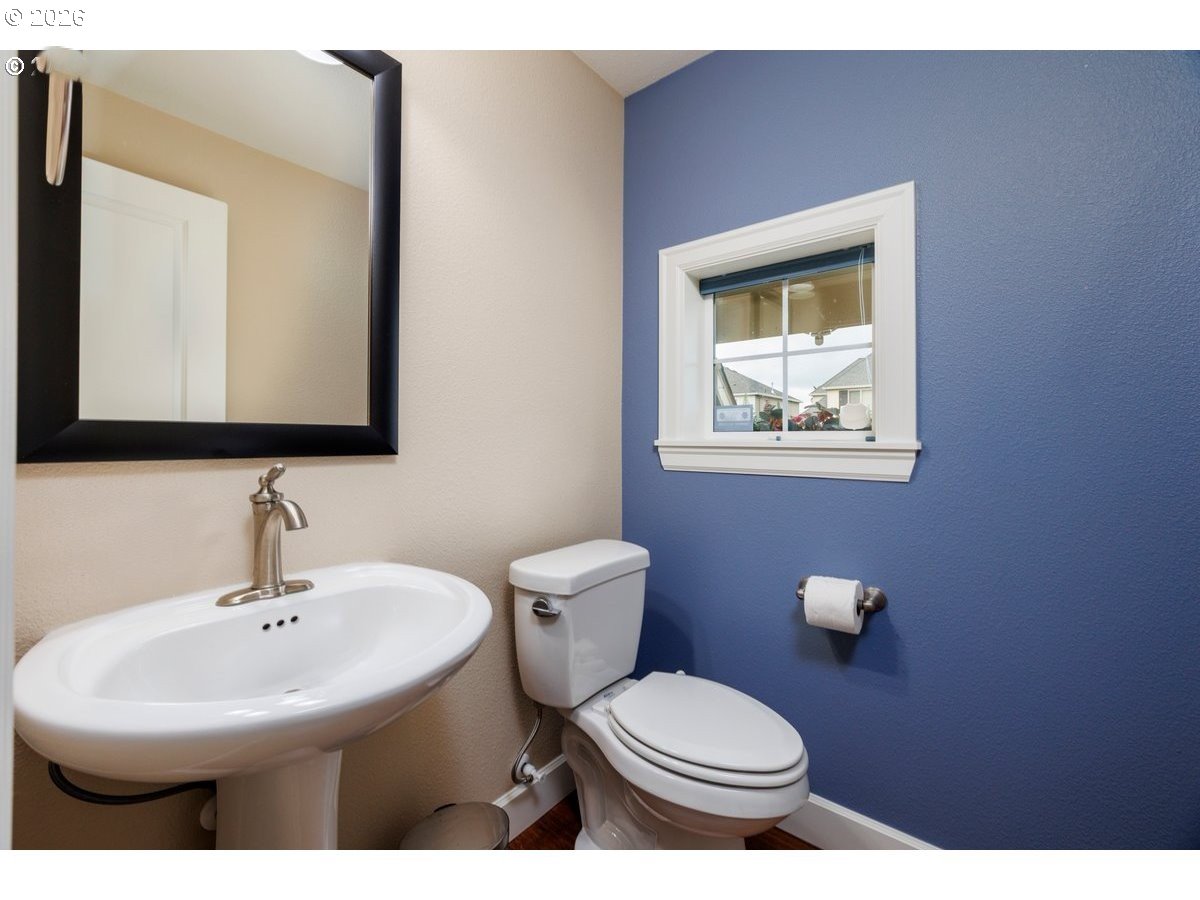 15997 Northwest Rossetta Street Portland, OR 97229 - Photo 16 of 36 a bathroom with a toilet sink and mirror