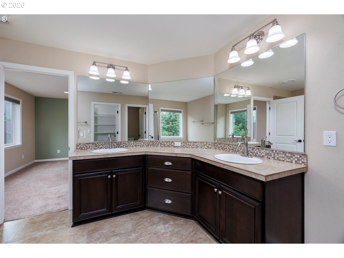 15997 Northwest Rossetta Street Portland, OR 97229 - Photo 20 of 36 a bathroom with a sink double vanity and a mirror