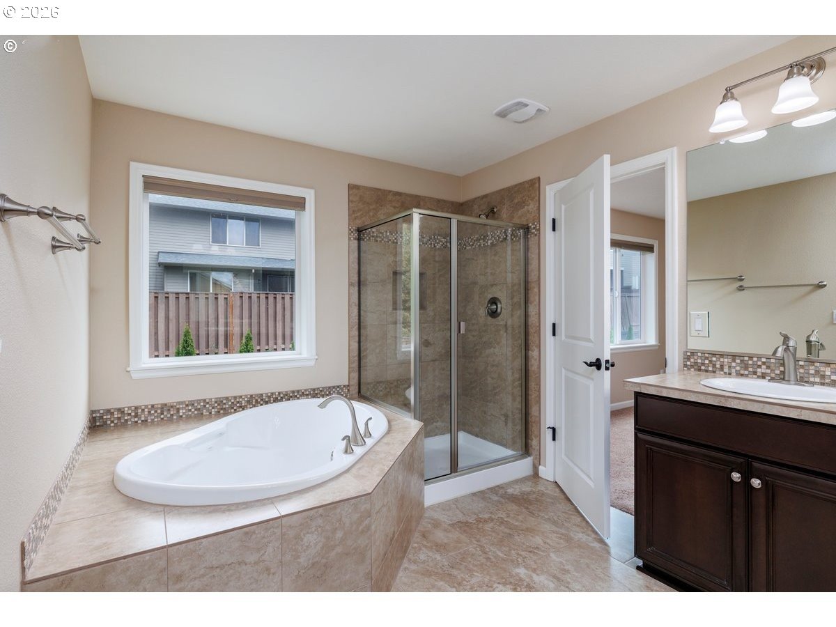 15997 Northwest Rossetta Street Portland, OR 97229 - Photo 21 of 36 a bathroom with a bathtub and a sink
