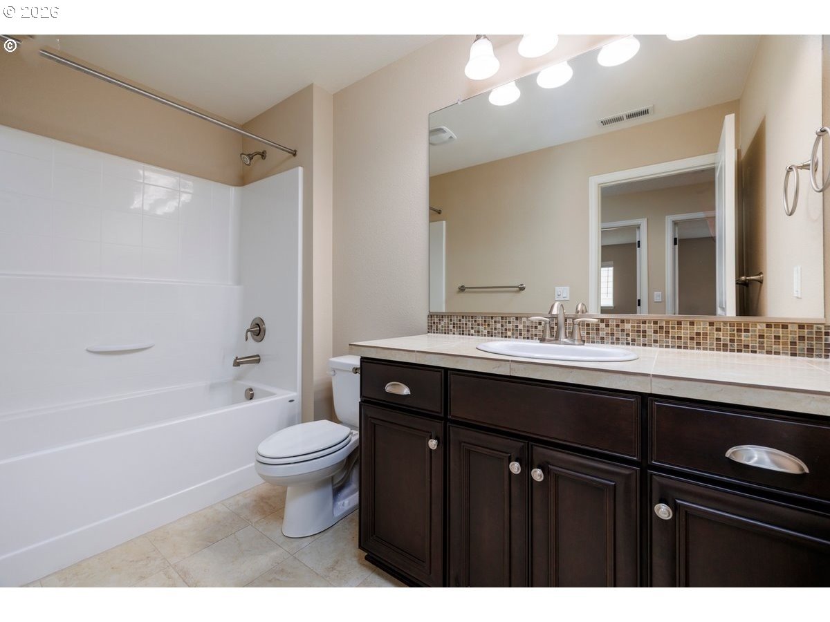15997 Northwest Rossetta Street Portland, OR 97229 - Photo 28 of 36 a bathroom with a sink vanity mirror and toilet