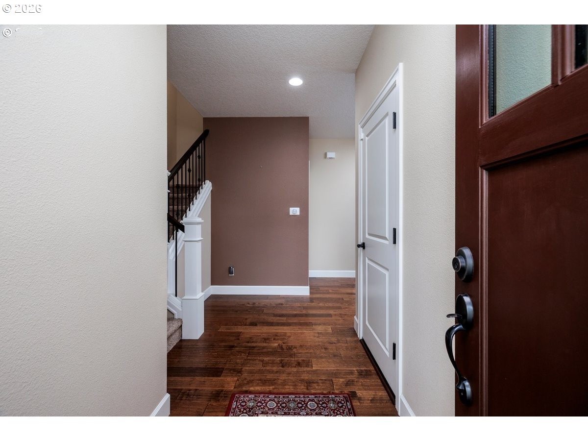 15997 Northwest Rossetta Street Portland, OR 97229 - Photo 4 of 36 a view of a hallway with wooden floor and staircase