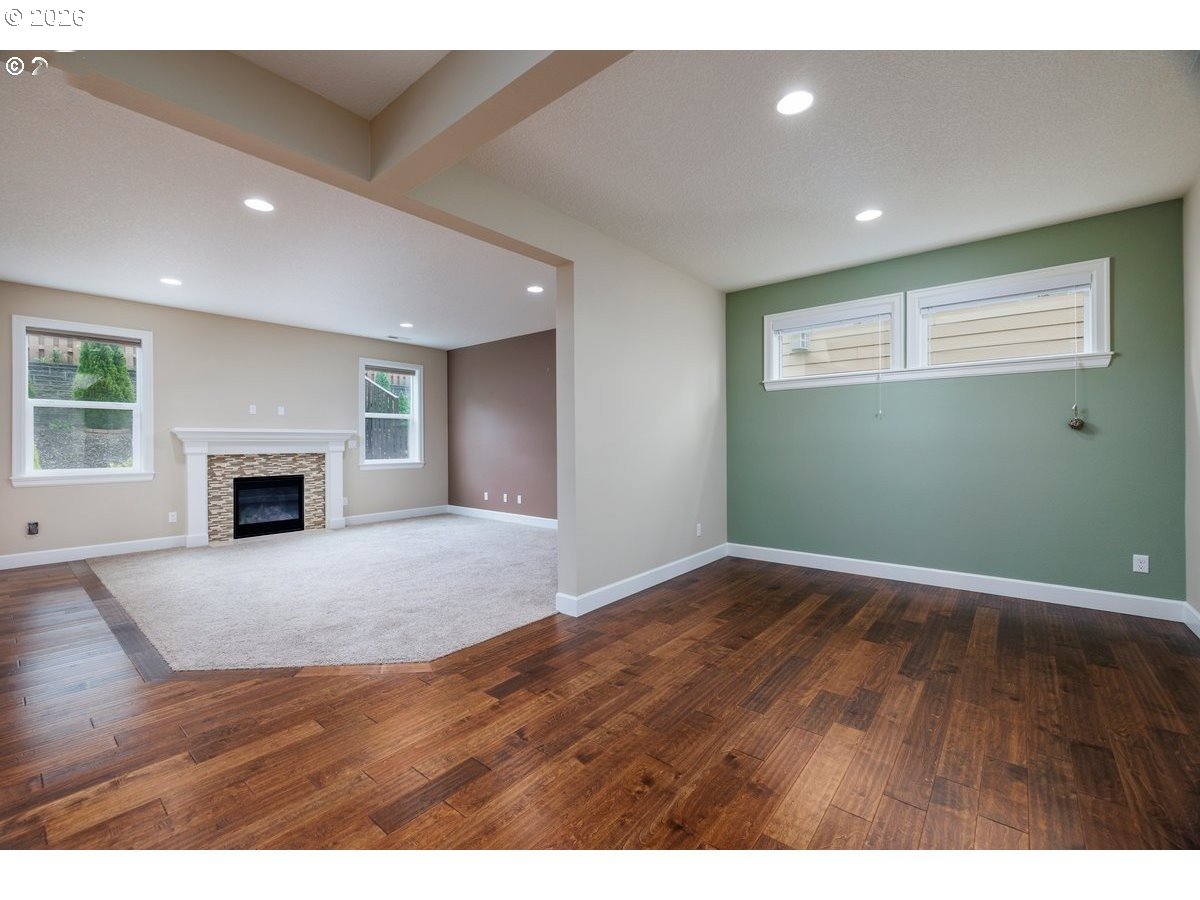 15997 Northwest Rossetta Street Portland, OR 97229 - Photo 7 of 36 a view of an empty room with wooden floor and a window
