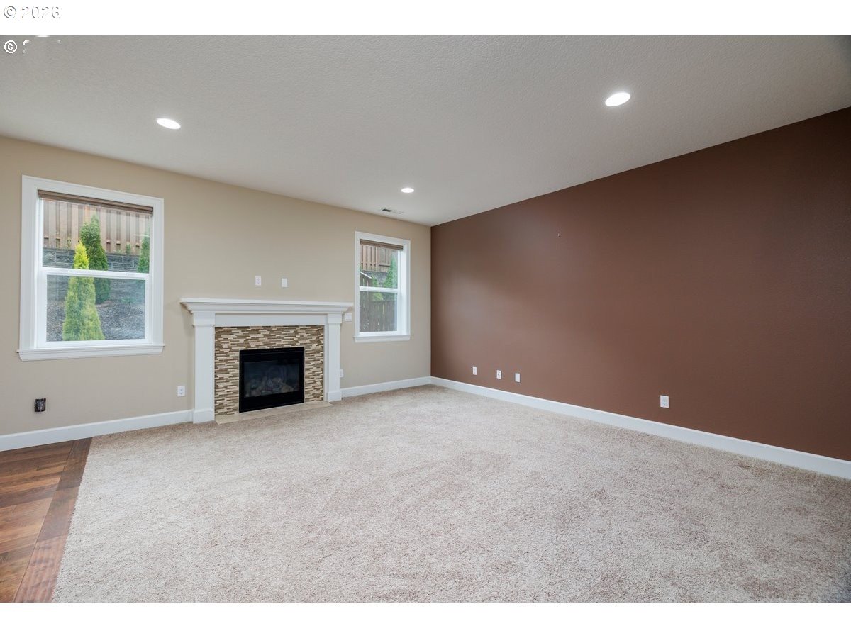 15997 Northwest Rossetta Street Portland, OR 97229 - Photo 9 of 36 a view of an empty room with a fireplace