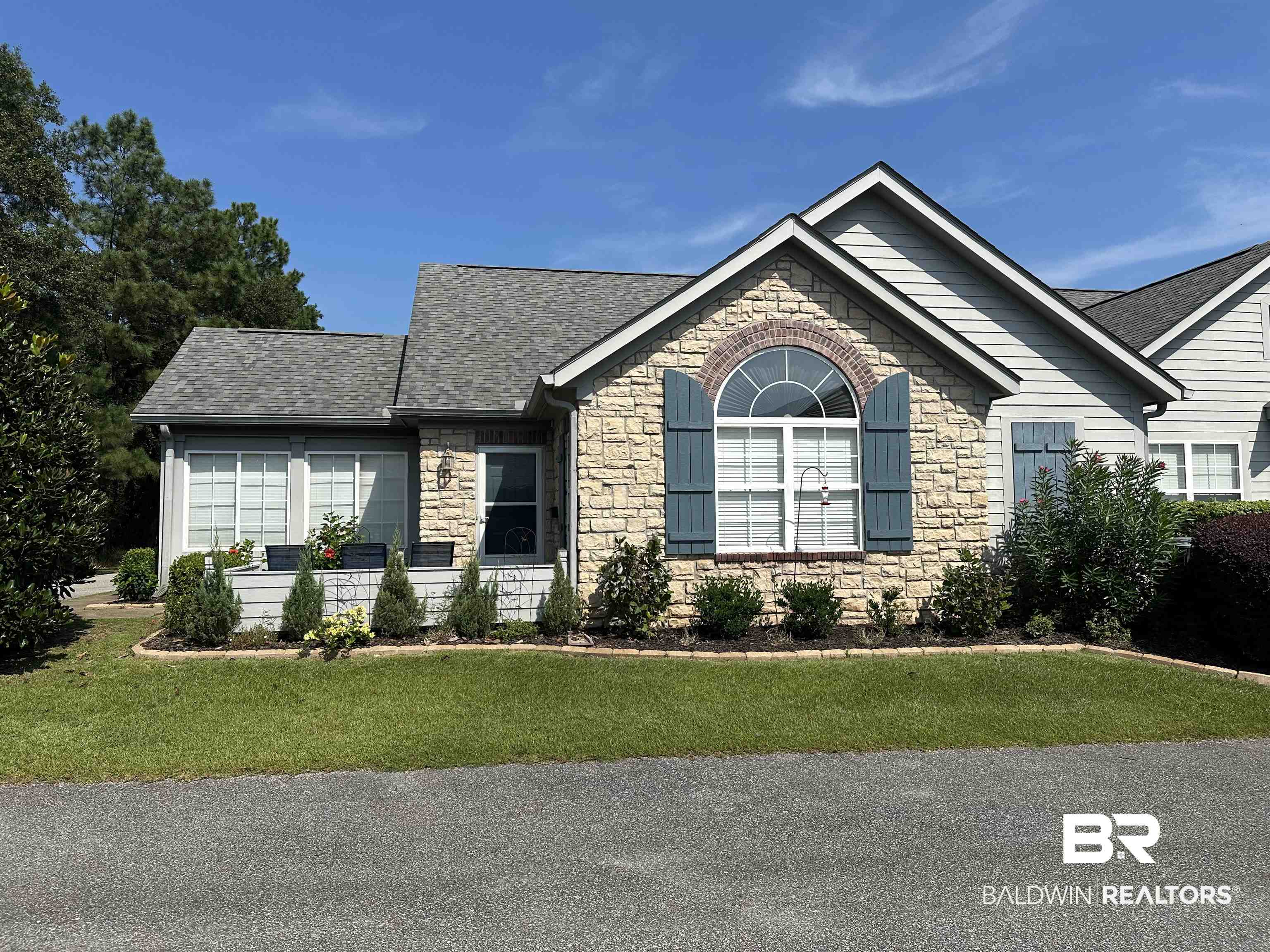 303 Wyld Palms Drive, Unit 303 Foley, AL 36535 - Photo 2 of 36 Ranch-style home with stone siding, a shingled roof, and a front yard