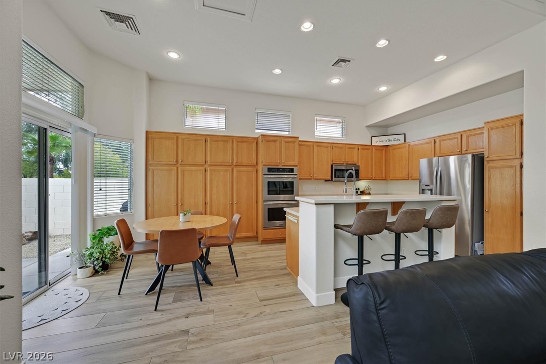 1259 Moon Vision Street Henderson, NV 89052 - Photo 8 of 53 A well-appointed kitchen showcasing recessed lighting and wood cabinetry throughout.