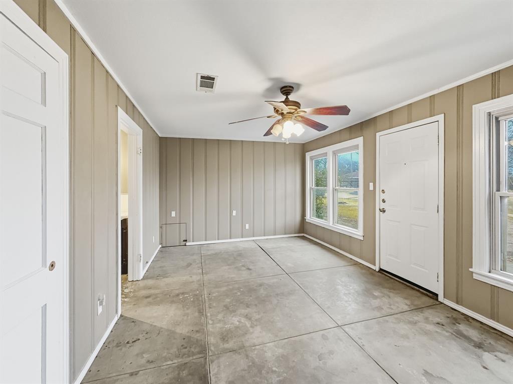 720 East Leslie Street Hamilton, TX 76531 - Photo 16 of 31 a view of an empty room with window and chandelier fan