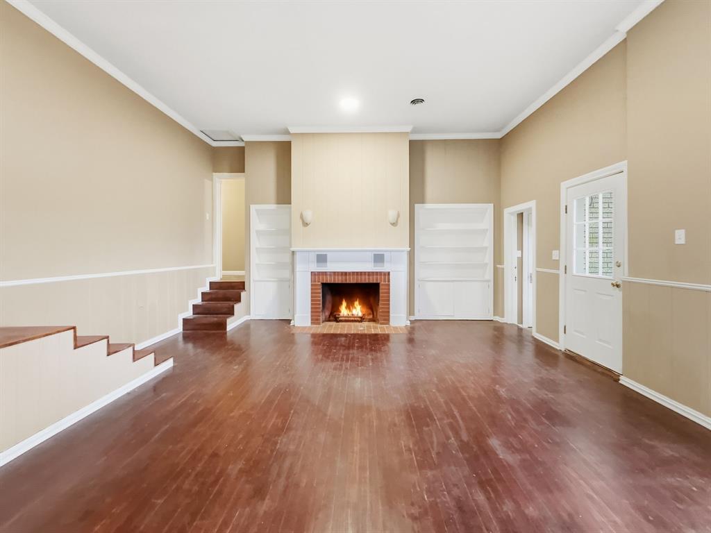 720 East Leslie Street Hamilton, TX 76531 - Photo 9 of 31 a view of an empty room with a fireplace and a window