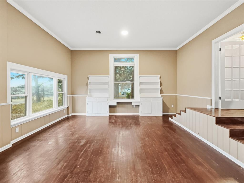 720 East Leslie Street Hamilton, TX 76531 - Photo 10 of 31 a view of empty room with wooden floor and fan