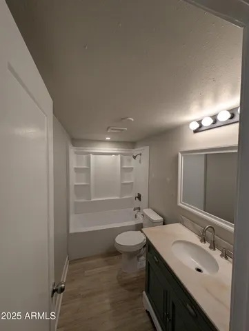 a bathroom with a double vanity sink toilet mirror and shower