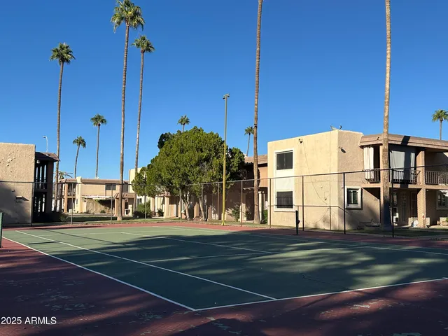 a view of a tall building next to a yard