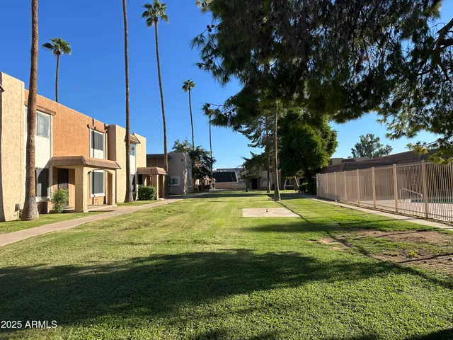 a swimming pool with yard and outdoor seating