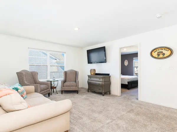 a spacious bedroom with a bed and a chair in it