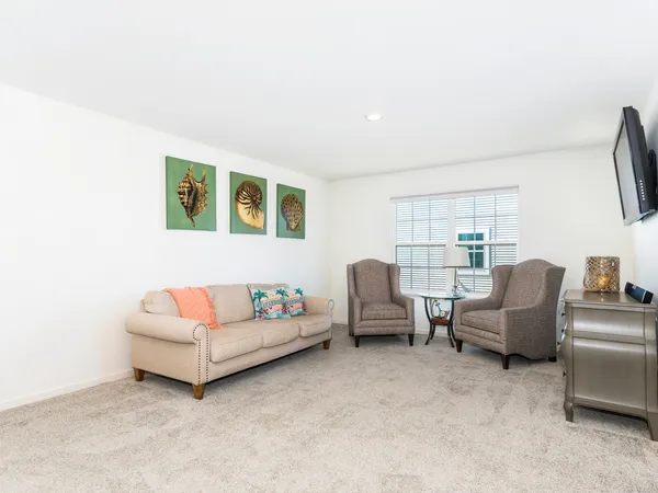 a spacious bedroom with a bed and a flat screen tv