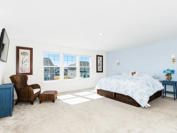 a spacious bathroom with a granite countertop sink mirror and bathtub