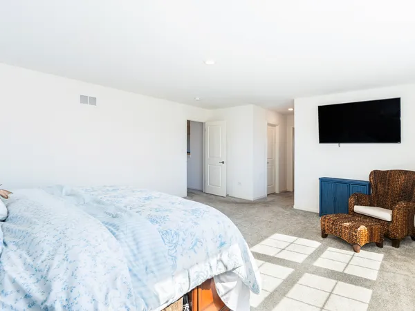 a view of a hallway with wooden floor and a shower