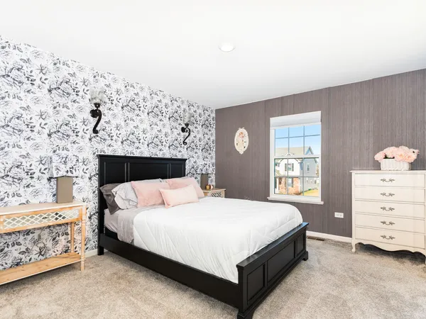 a bedroom with a bed and a dresser in it