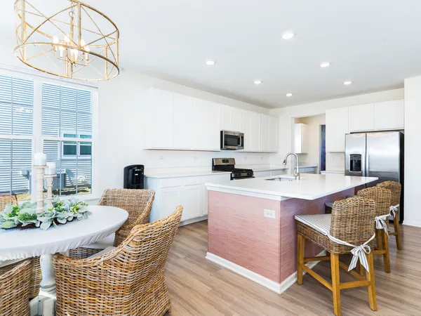 a kitchen with stainless steel appliances kitchen island granite countertop a sink and cabinets