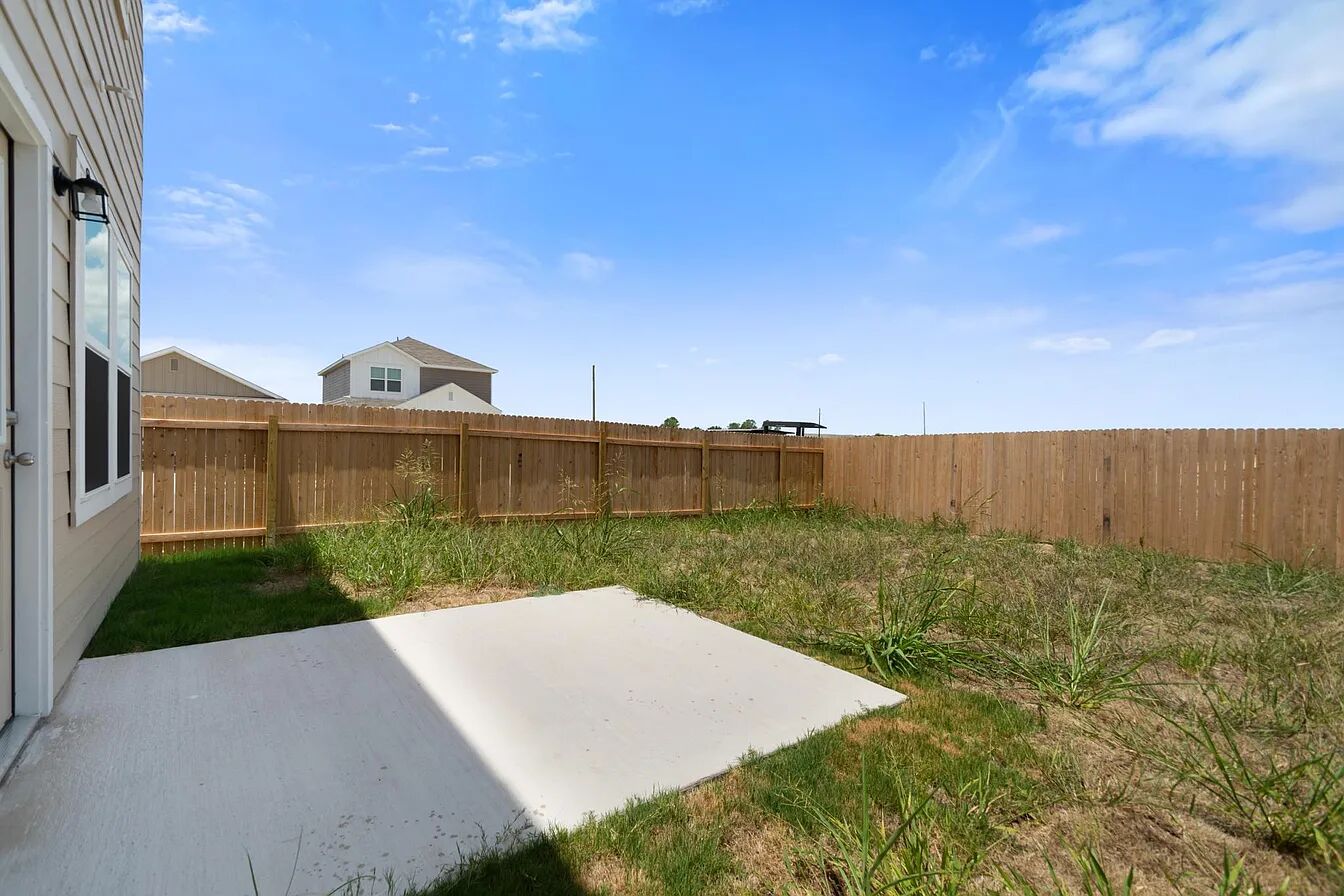 101 Aoudad Road Hutto, TX 78634 - Photo 36 of 39 A spacious backyard awaits, ready for your personal touch, complete with a private patio and durable wood fencing.