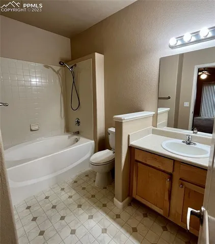 a bathroom with a sink toilet vanity and shower