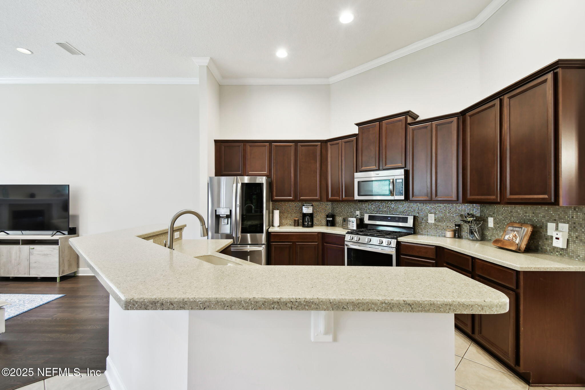 6003 Shadehill Road Jacksonville, FL 32258 - Photo 11 of 46 a kitchen with stainless steel appliances granite countertop a sink a stove top oven a counter space and cabinets