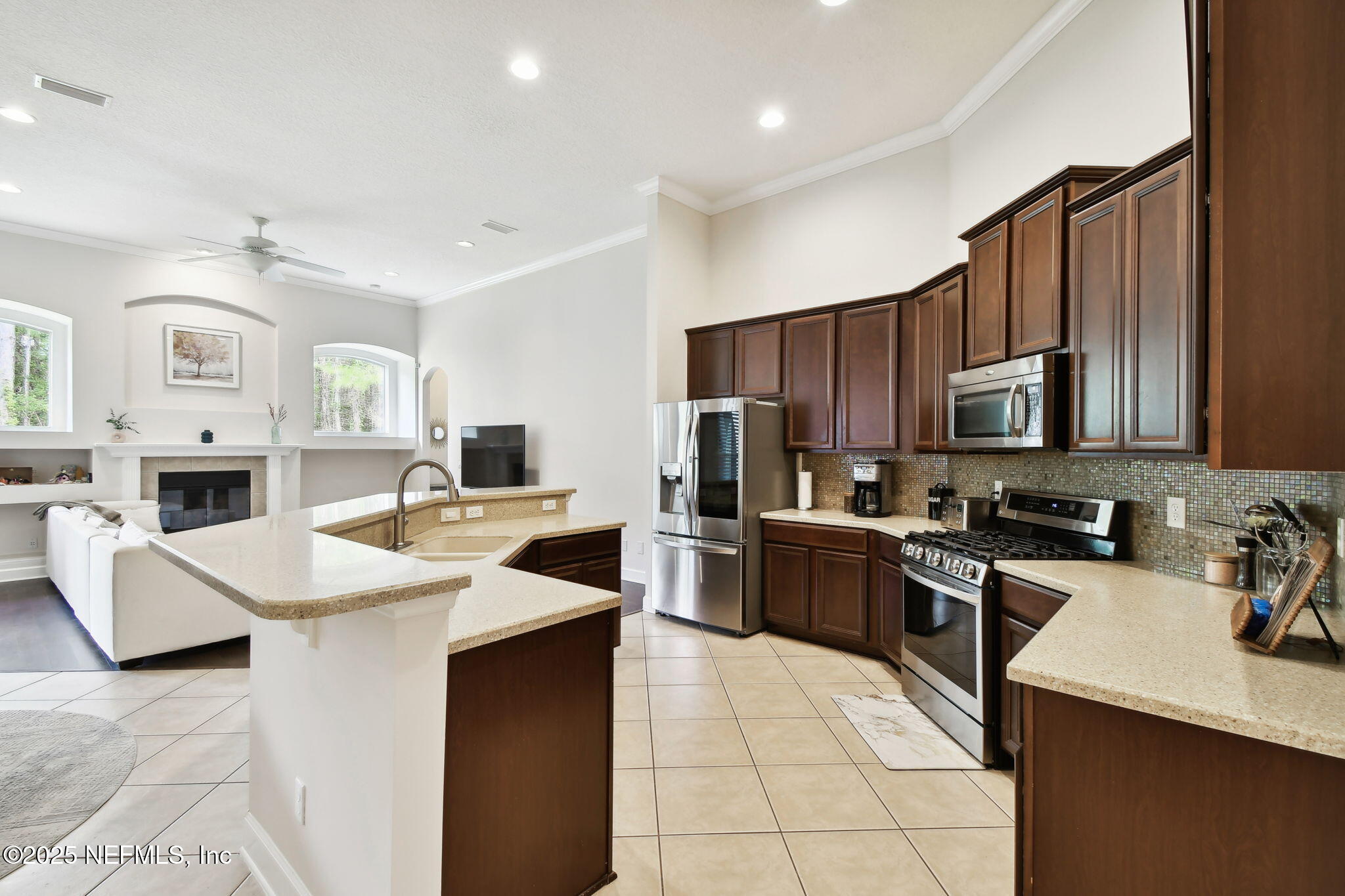 6003 Shadehill Road Jacksonville, FL 32258 - Photo 12 of 46 a kitchen with a sink a stove top oven and refrigerator