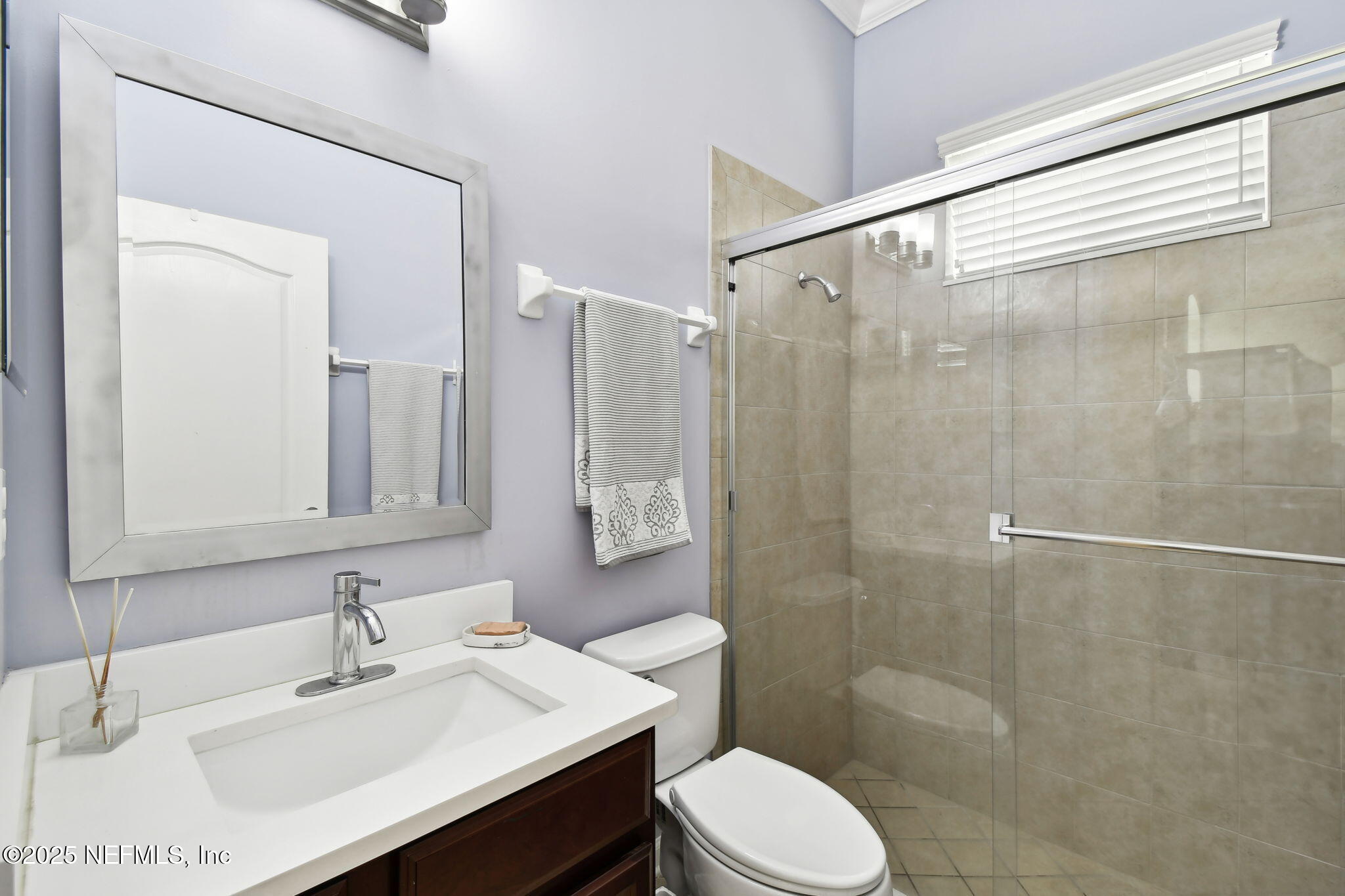 6003 Shadehill Road Jacksonville, FL 32258 - Photo 17 of 46 a bathroom with a sink toilet a mirror and shower