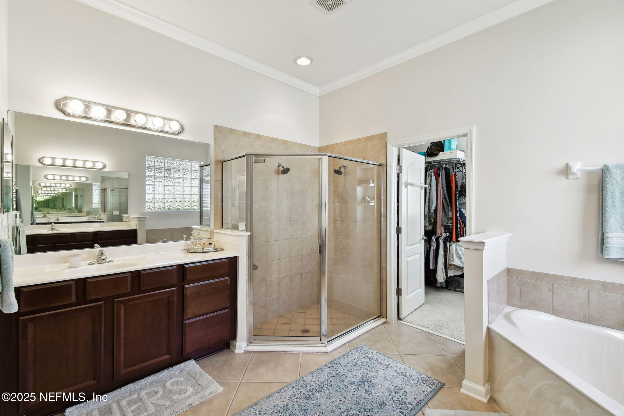 6003 Shadehill Road Jacksonville, FL 32258 - Photo 21 of 46 a large bathroom with a double vanity sink a mirror and shower