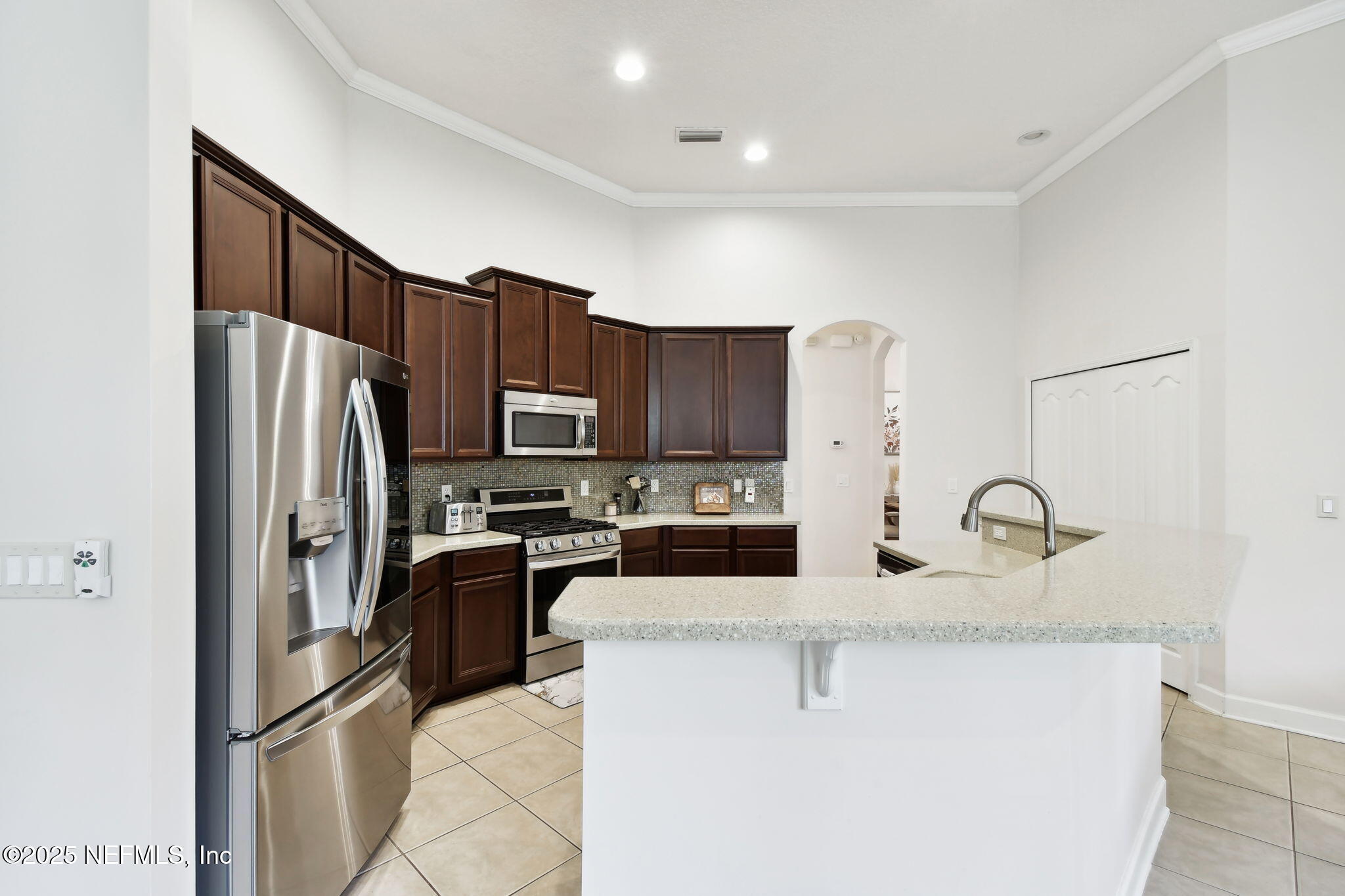 6003 Shadehill Road Jacksonville, FL 32258 - Photo 8 of 46 a kitchen with granite countertop a refrigerator and a stove top oven