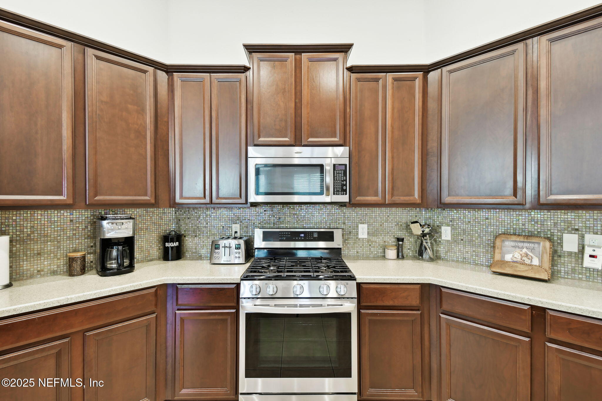 6003 Shadehill Road Jacksonville, FL 32258 - Photo 9 of 46 a kitchen with stainless steel appliances wooden cabinets and a counter top space