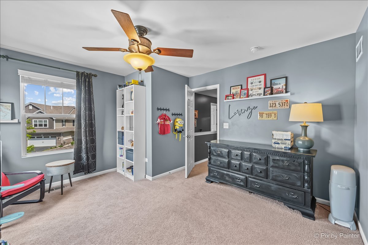 16207 West Switch Grass Road Lockport, IL 60441 - Photo 26 of 45 a bed room with a bed and a chandelier