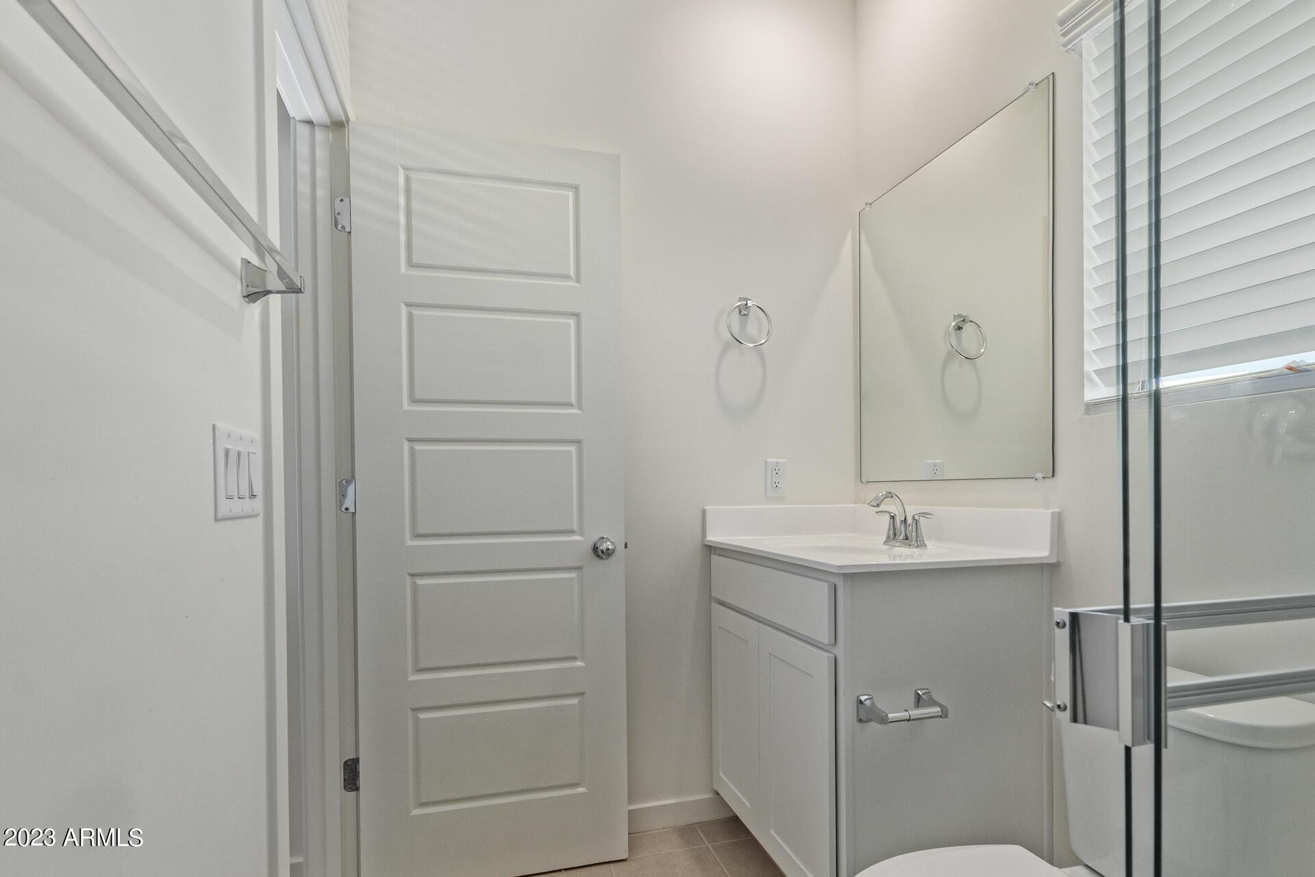 2280 West Laurie Lane Phoenix, AZ 85021 - Photo 14 of 27 a bathroom with a shower sink and mirror