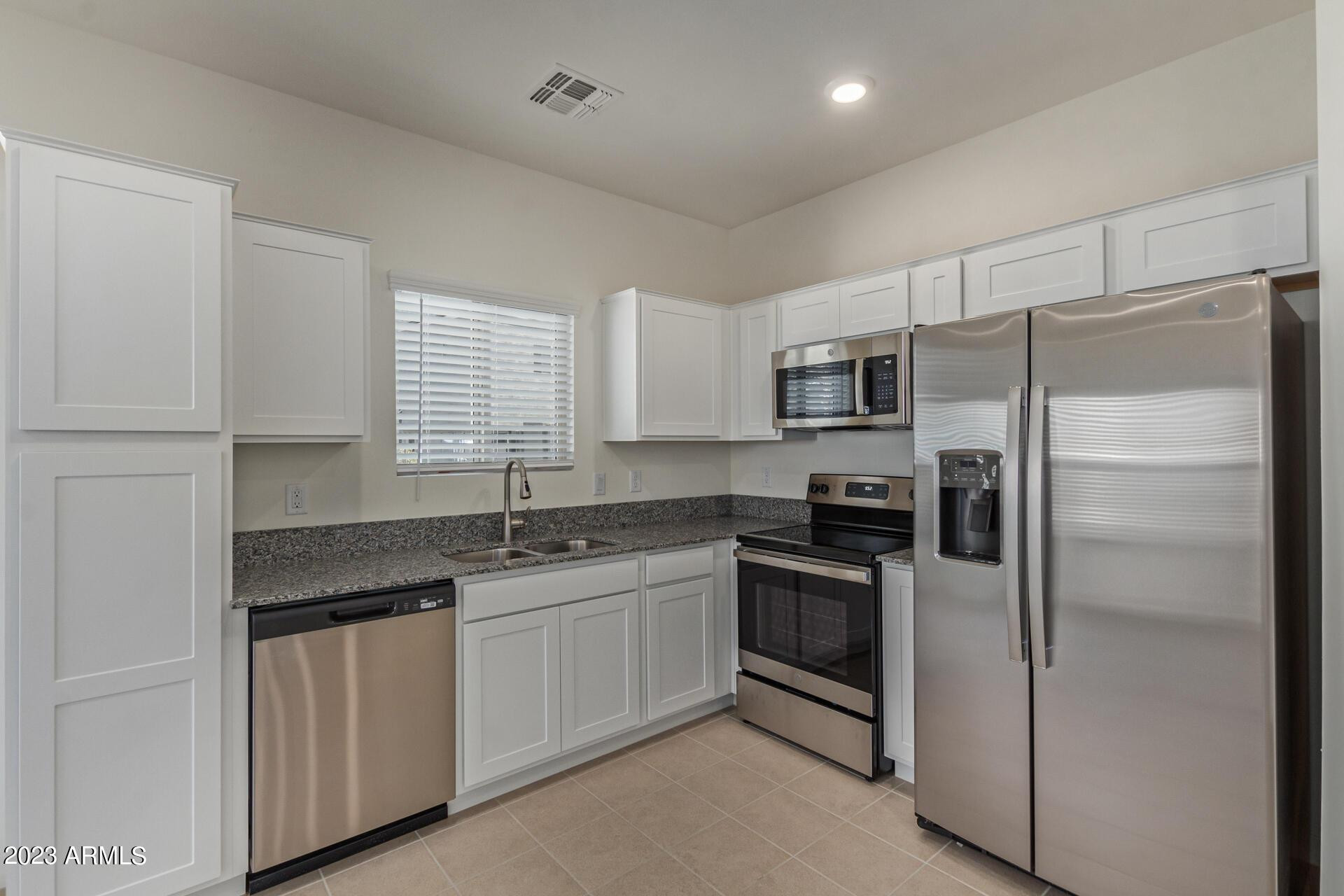2280 West Laurie Lane Phoenix, AZ 85021 - Photo 6 of 27 a kitchen with a sink stainless steel appliances and window