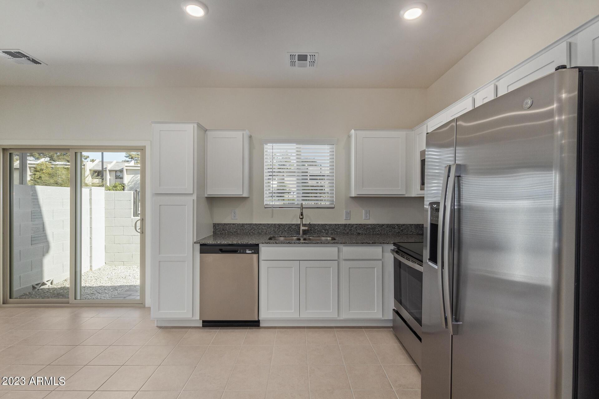2280 West Laurie Lane Phoenix, AZ 85021 - Photo 8 of 27 a kitchen with stainless steel appliances granite countertop a refrigerator and a sink