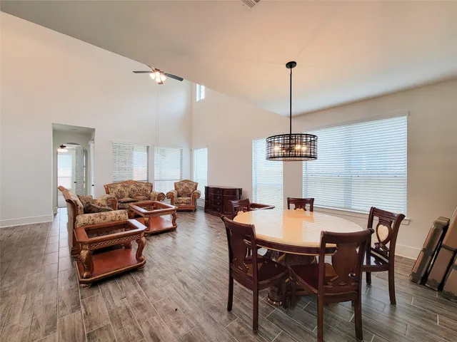 a dining room with furniture window and wooden floor