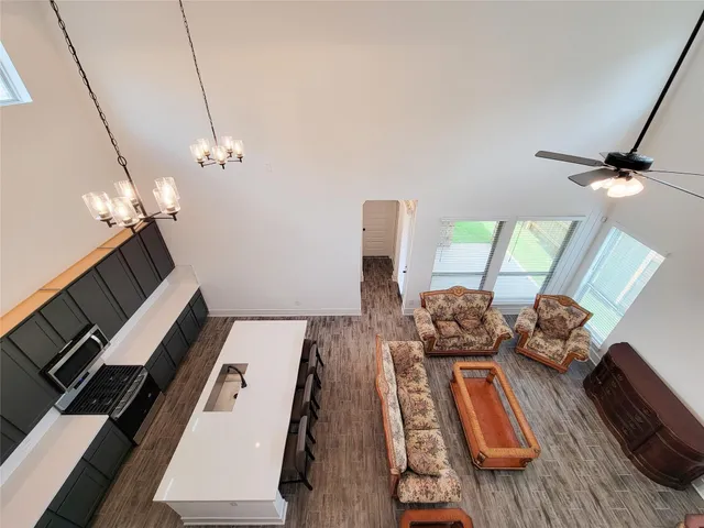 an empty room with a ceiling fan and window