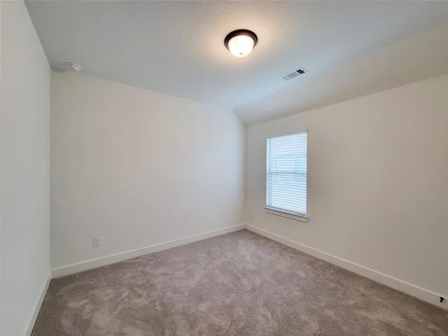 a bathroom with a granite countertop double vanity sink a bathtub and mirror