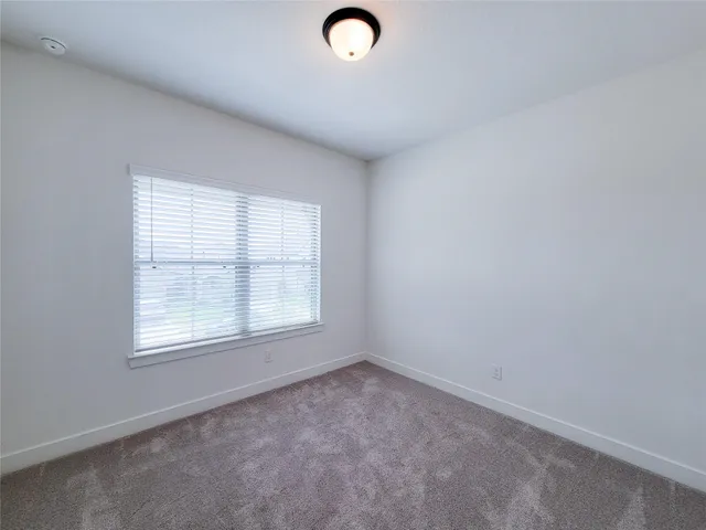 a spacious bathroom with a bathtub shower sink mirror and toilet