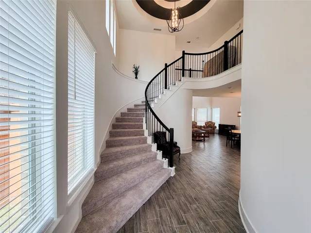 a kitchen with wooden cabinets a sink and white appliances