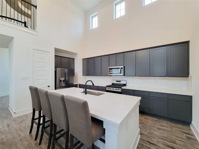 a kitchen with a sink stove and cabinets