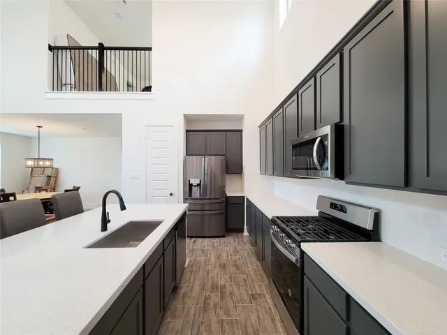 a kitchen with stainless steel appliances a sink and a stove top oven