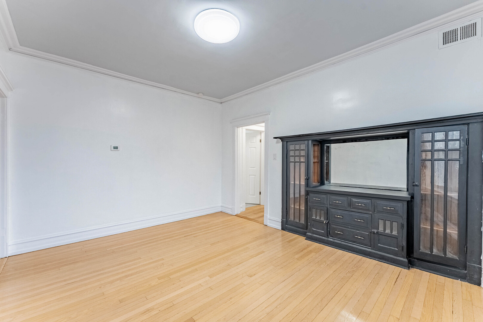 4200 West 21st Place, Unit 2F Chicago, IL 60623 - Photo 11 of 19 a big room with wooden floor and windows