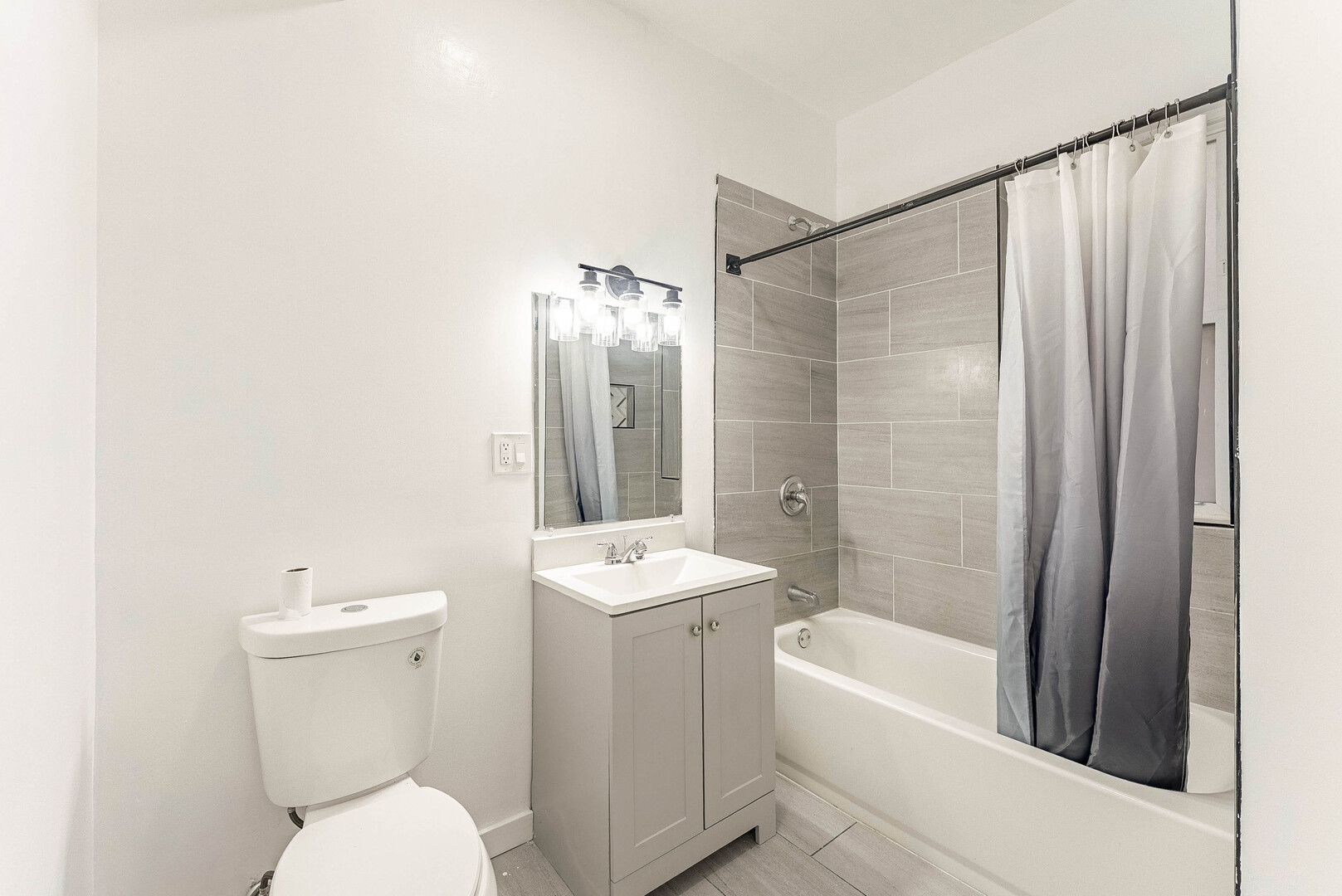 4200 West 21st Place, Unit 2F Chicago, IL 60623 - Photo 12 of 19 a bathroom with a sink a toilet and shower