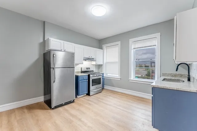 a kitchen with a refrigerator and a sink
