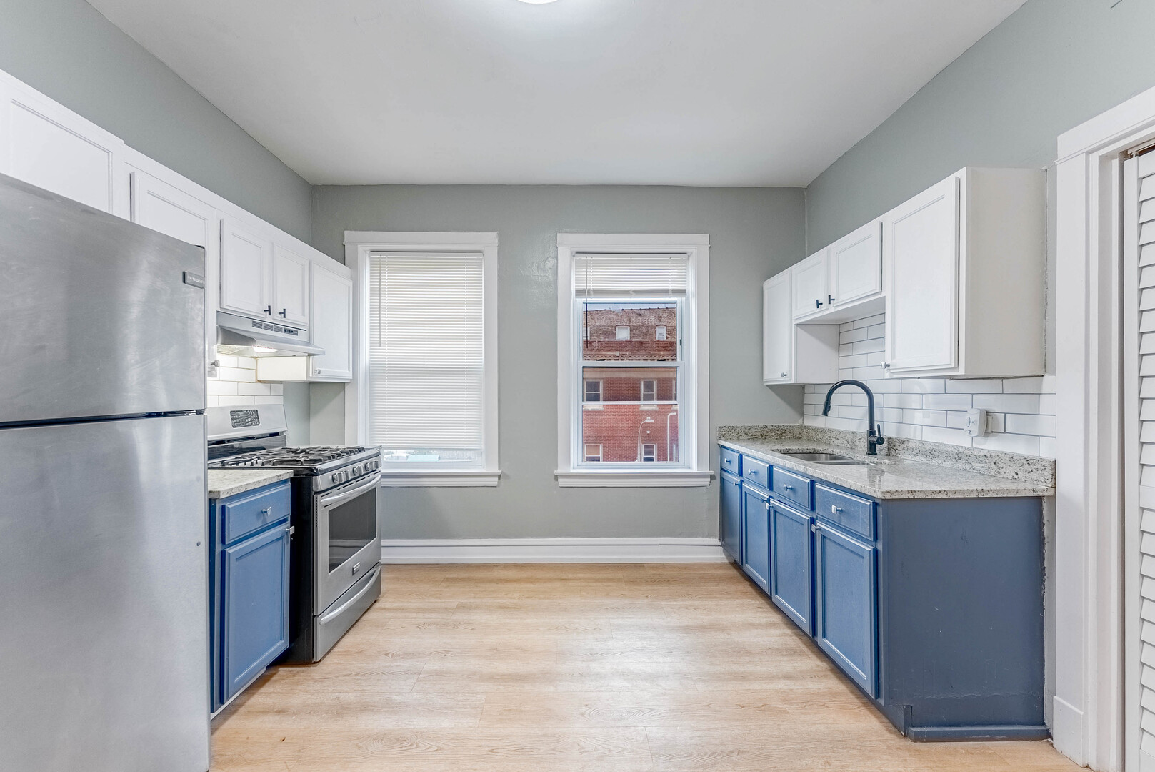 4200 West 21st Place, Unit 2F Chicago, IL 60623 - Photo 16 of 19 a kitchen with stainless steel appliances granite countertop a sink stove and refrigerator