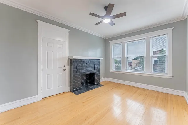 a view of empty room with a fireplace and fan