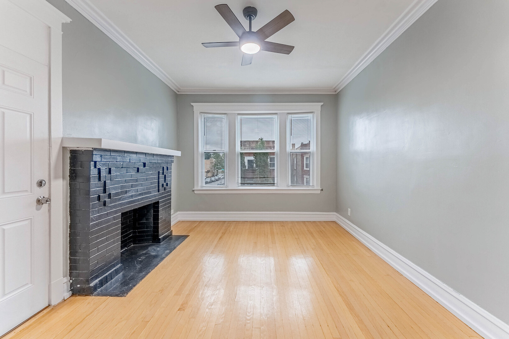 4200 West 21st Place, Unit 2F Chicago, IL 60623 - Photo 4 of 19 a view of an empty room with a fireplace and a window