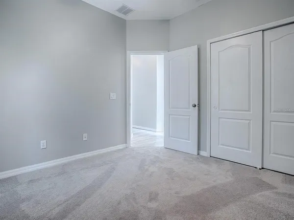 a view of an empty room and closet area